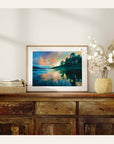 Framed artwork of a landscape print on a wooden sideboard with decorative items.