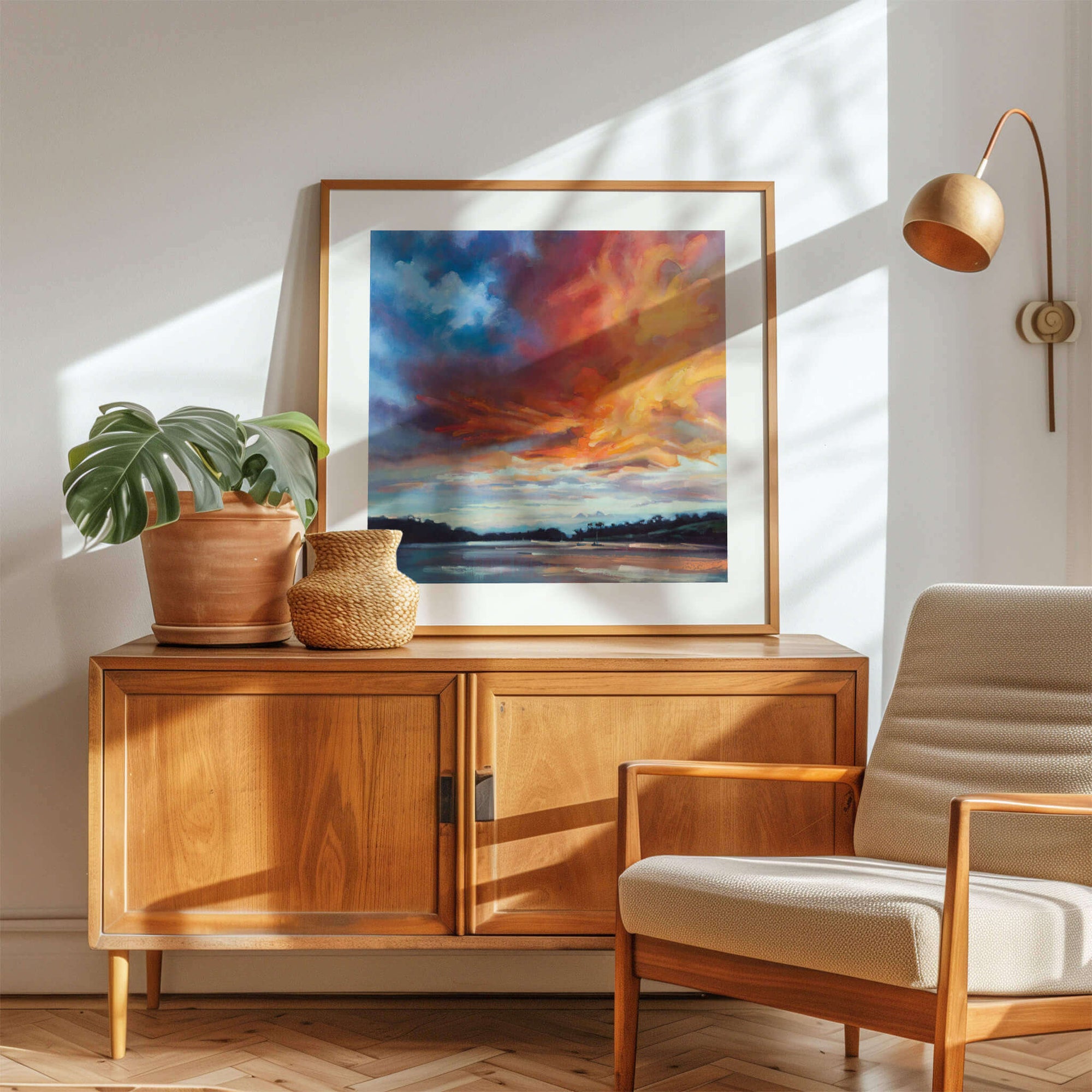 Wooden sideboard with decorative items and a colourful Cornwall art print in a living room - by Rachel Painter, contemporary landscape artist