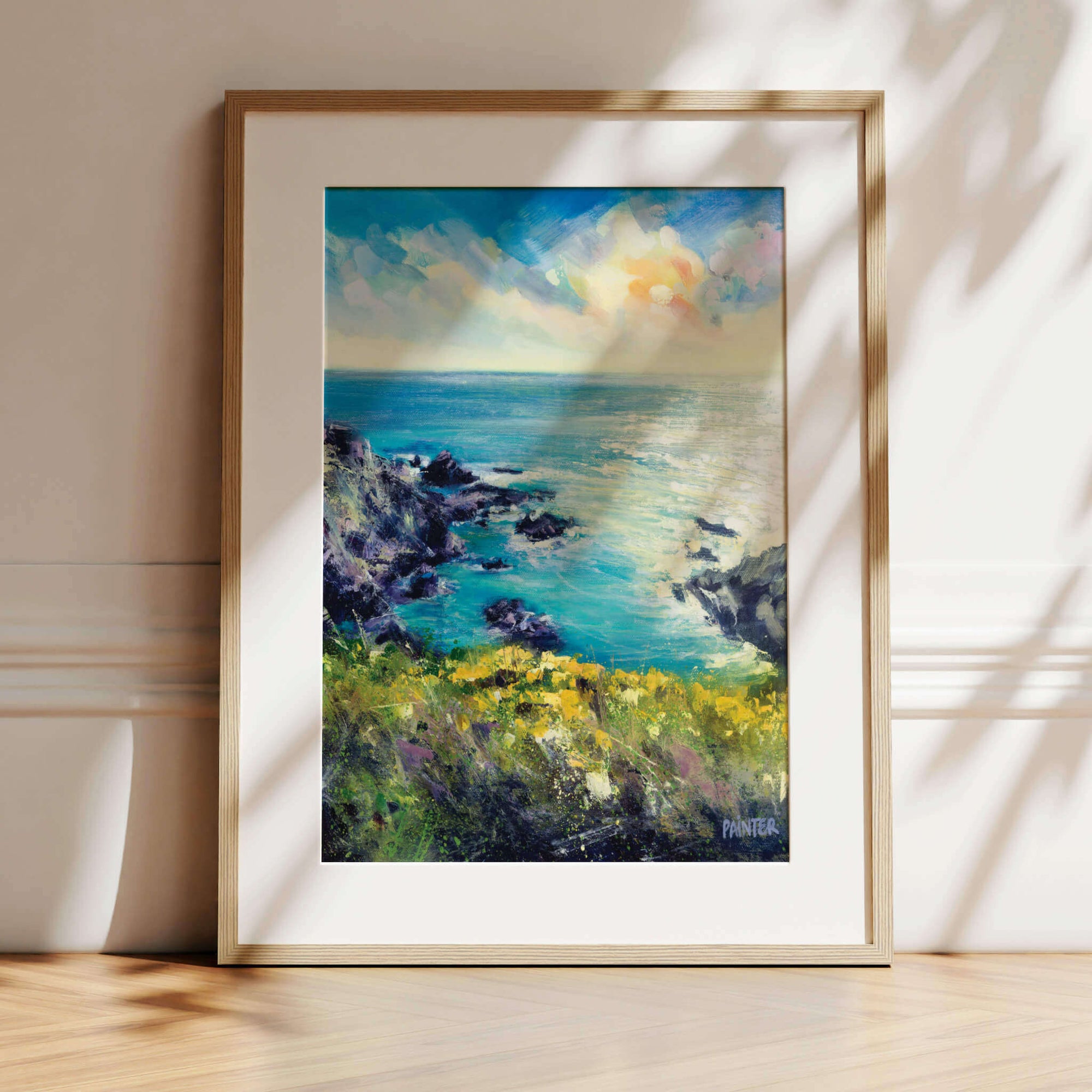 Wild and Free, framed artwork in oak ready hang of the Cornish coast near Porthleven with rugged cliffs, sea flowers overlooking a sunset sea by Cornwall artist Rachel Painter
