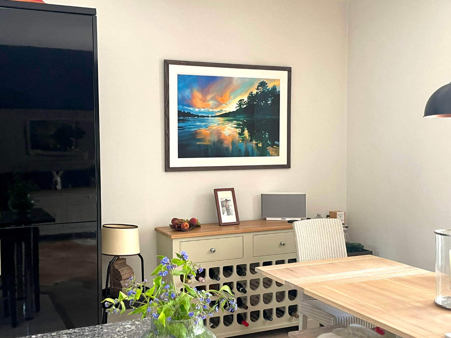 Modern interior with a landscape wall art print of a Cornwall sunset over water at the Helford River