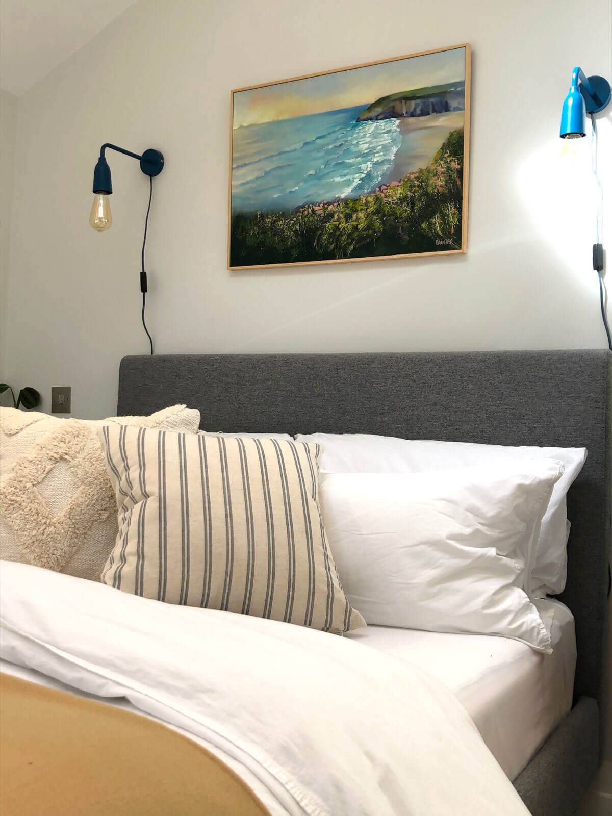 Framed custom painting commission of Mawgan Porth in Cornwall from the clifftops with coastal flowers at sunset as an wedding gift for wife.