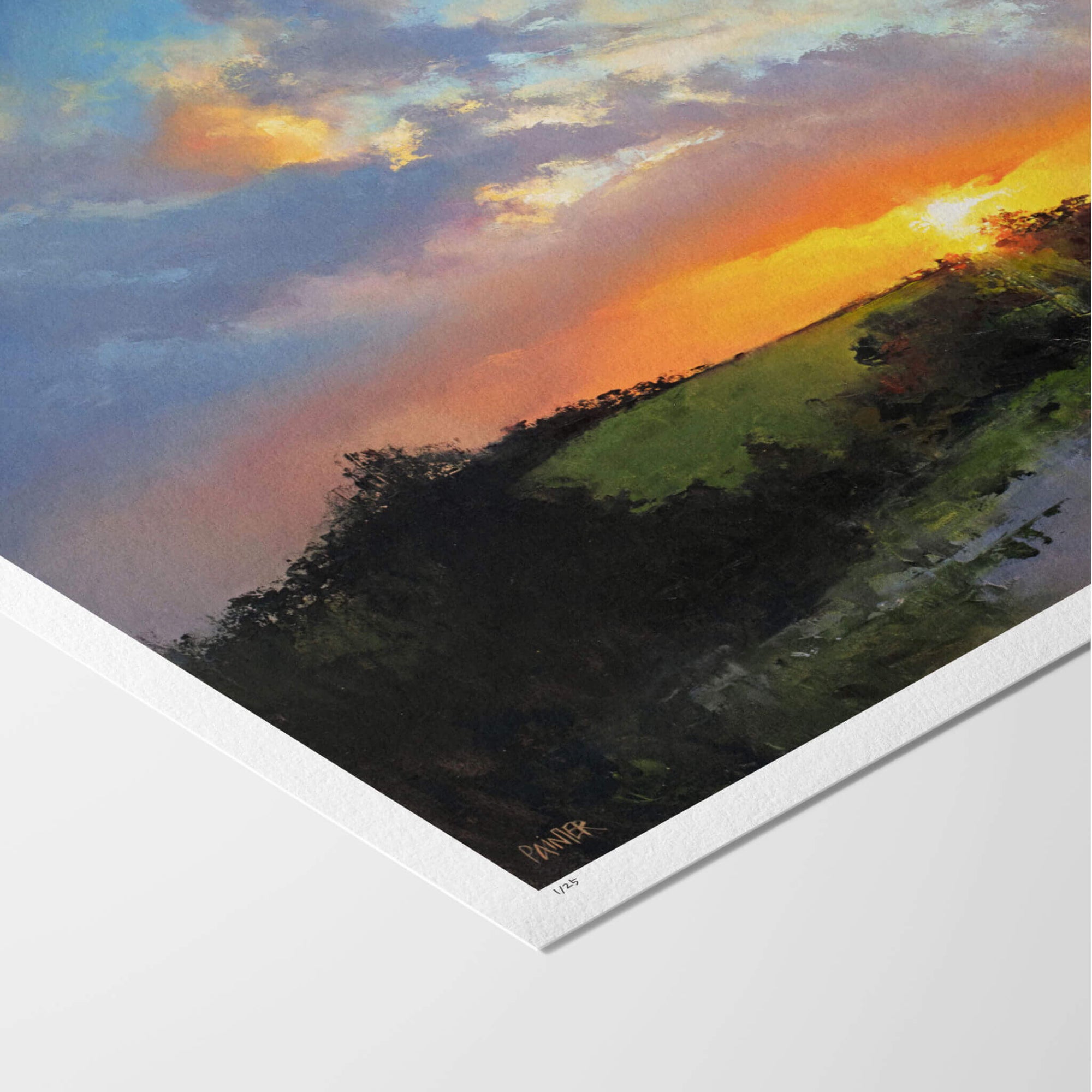 Fine art paper print with white border of a landscape with a colourful sky and green hillside.