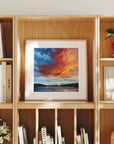 Framed artwork on a wooden bookshelf with books and decorative items.
