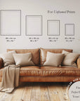 Brown leather sofa with pillows in a room setting, featuring size charts for unframed prints.