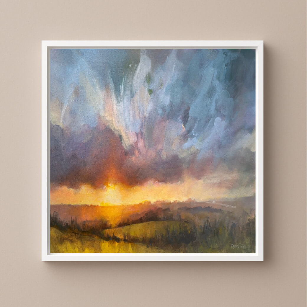 Framed abstract painting of a sunset over a landscape on a warm neutral wall